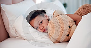 Healthcare, sick child in bed with teddy bear with cold or flu in home, sad and tired with rest. Illness, fever and face