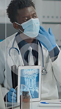 Healthcare specialist holdind x ray on tablet