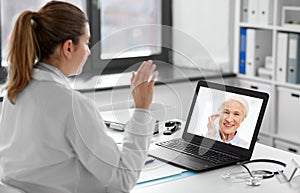 doctor with laptop having video call with patient