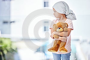 Healthcare, teddy bear and child cancer patient holding her toy for support or comfort. Medical, recovery and girl kid
