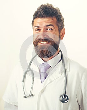 Healthcare, treatment and medical staff concept. Portrait of smiling man doctor in medical gown with stethoscope on neck