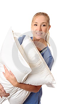 Healthcare worker carrying patient pillows
