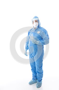 Healthcare worker in full PPE holding swabs for coronavirus pandemic