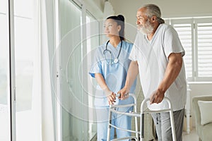 Healthcare worker with man using walking support