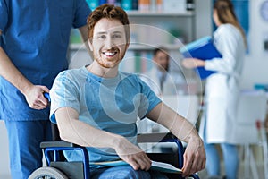 Healthcare worker pushing a man in wheelchair