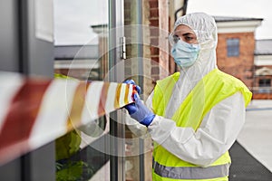 Healthcare worker sealing door with caution tape
