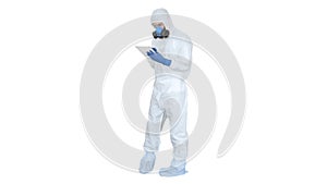 Healthcare worker wearing hazmat suit working on digital tablet on white background.