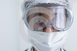 Healthcare worker wearing protective suit and face mask during coronavirus Covid19 pandemic