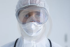 Healthcare worker wearing protective suit and face mask during coronavirus Covid19 pandemic