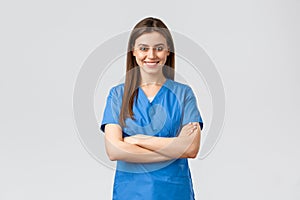 Healthcare workers, prevent virus, insurance and medicine concept. Confident female doctor, nurse in blue scrubs