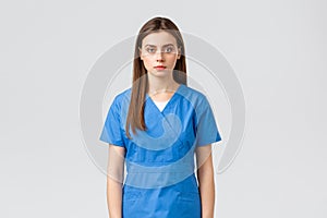 Healthcare workers, prevent virus, insurance and medicine concept. Serious-looking young medical worker, nurse or doctor