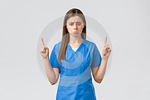 Healthcare workers, prevent virus, insurance and medicine concept. Upset sobbing cute nurse or doctor in blue scrubs