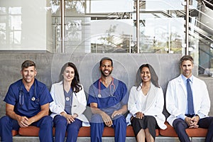 Healthcare workers sitting in hospital, three quarter length photo