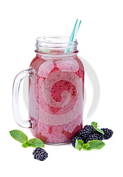 A blackberries pink drink, on a white background. Organic berry milk in a mason jar. Healthful smoothie.