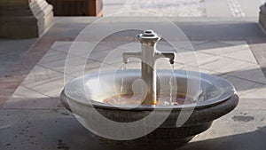 Healthful hot mineral water flowing from faucet indoors in health resort. Thermal waters in Czech Republic in Karlovy