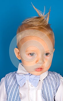 Healthier hair from root to tip. Small child with messy top haircut. Boy child with stylish blond hair. Small boy with