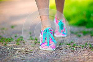 Healthy active lifestyle woman athlete tying running shoes. Sporty girl getting ready for jogging workout. Closeup of