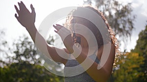 Healthy active sportswoman stretch hands stretching shoulders muscles workout in park outdoors sun background sport girl