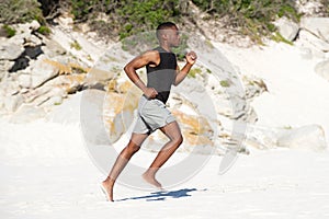 Healthy active young african man running on the beach