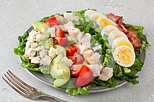 Healthy American Cobb salad with egg bacon avocado chicken tomato. hearty keto low carb diet