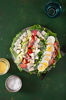 Healthy American Cobb salad with egg bacon avocado chicken tomato. hearty keto low carb diet