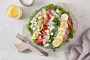 healthy American Cobb salad with egg bacon avocado chicken tomato. hearty keto low carb diet