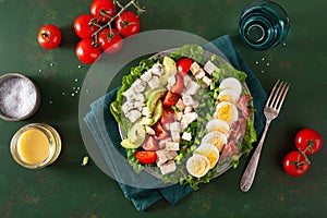 healthy American Cobb salad with egg bacon avocado chicken tomato. hearty keto low carb diet