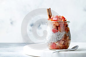 Healthy apple pie chia pudding with cinnamon in a glass jar. Seasonal autumn breakfast. Vegan healthy breakfast