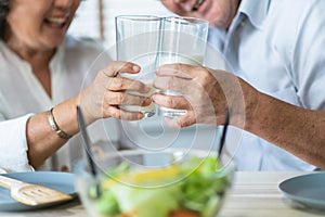 Healthy asian Elderly couple enjoying drinking fresh milk from glass