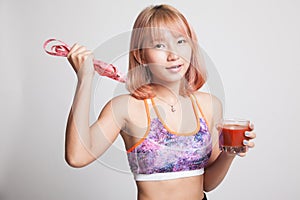 Healthy Asian girl diet with tomato juice and measuring tape on