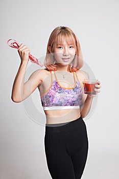 Healthy Asian girl diet with tomato juice and measuring tape on