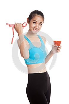 Healthy Asian girl diet with tomato juice and measuring tape on