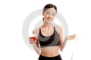 Healthy Asian girl diet with tomato juice and measuring tape on