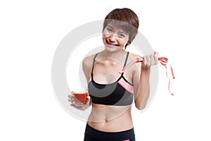 Healthy Asian girl diet with tomato juice and measuring tape on