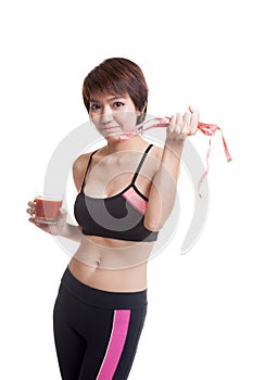 Healthy Asian girl diet with tomato juice and measuring tape on