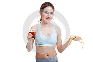 Healthy Asian girl diet with tomato juice and measuring tape on