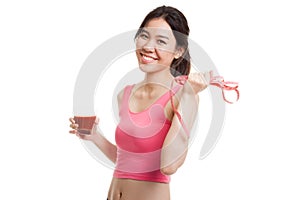 Healthy Asian girl diet with tomato juice and measuring tape on