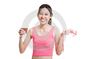 Healthy Asian girl diet with tomato juice and measuring tape on