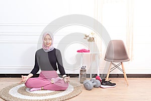 Healthy asian muslim woman with hijab doing exercise at home