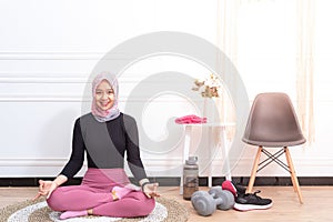 Healthy asian muslim woman with hijab doing exercise at home