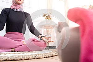 Healthy asian muslim woman with hijab doing exercise at home