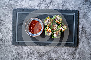 Healthy Asian Vietnamese Spring Roll / Goicuon with Rice Paper Rolls and Red Hot Chili Sauce