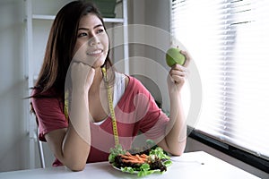 Healthy Asian woman chooses to eat fruits and vegetables for her health.