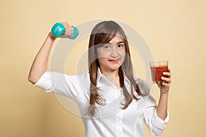 Healthy Asian woman with dumbbell and  tomato juice