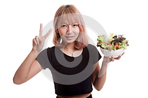 Healthy Asian woman show victory sign with salad.