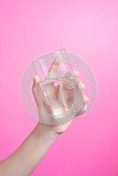Healthy asian young beautiful woman drinking water, beauty face natural makeup, isolated over pink background.