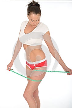 Healthy Attractive Fit Young Woman Checking Her Weight Loss With a Tape Measure