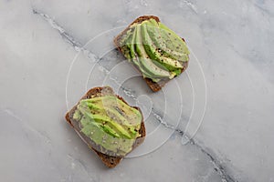 Healthy avocado toast. Mashed avocado on whole grain rye bread