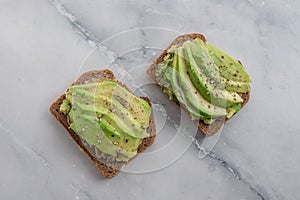 Healthy avocado toast. Mashed avocado on whole grain rye bread