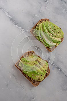 Healthy avocado toast. Mashed avocado on whole grain rye bread